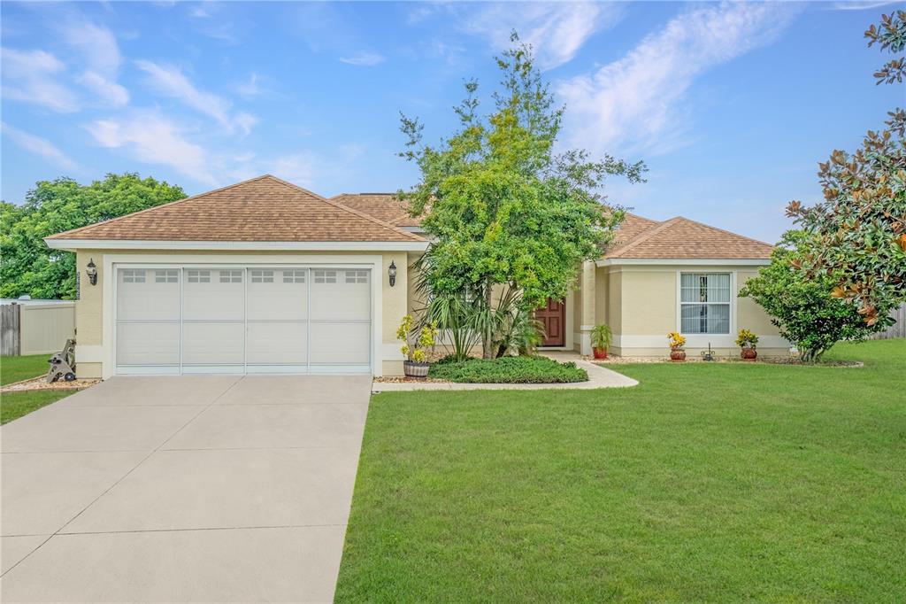 a front view of a house with a yard and garage