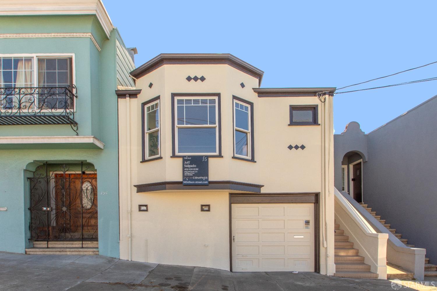 a front view of a house with large windows