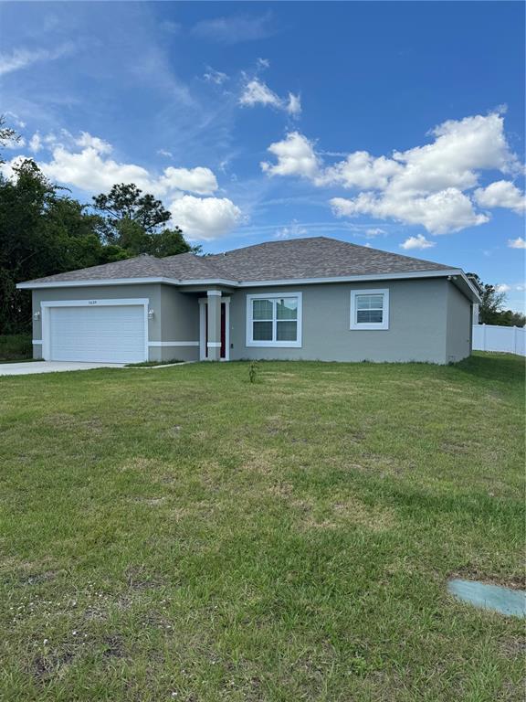 a view of a house with a yard