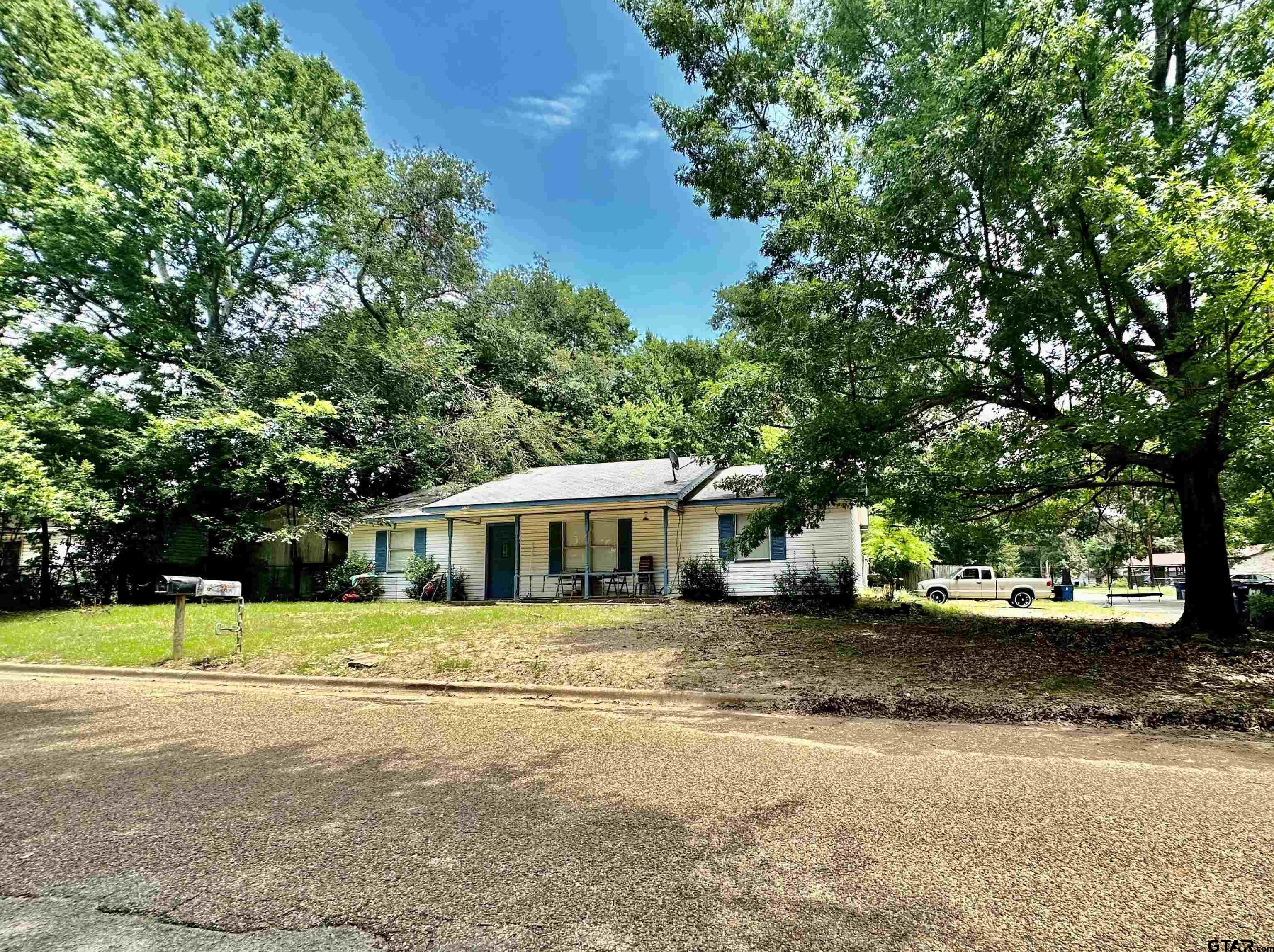 a view of a house with a yard