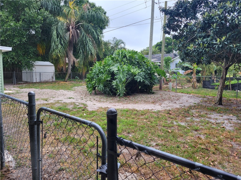 a view of a wooden fence and trees