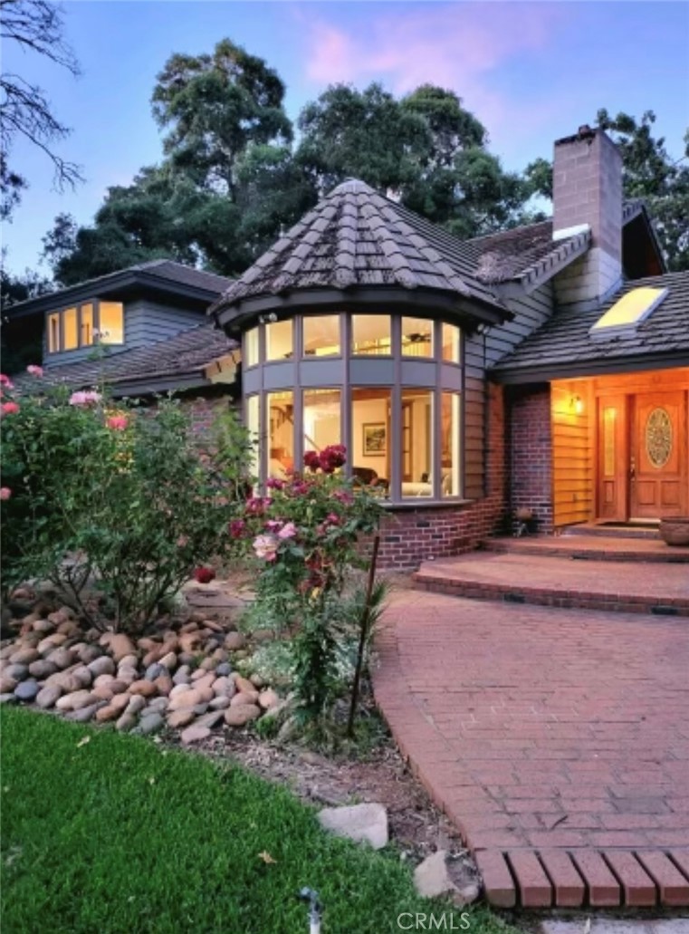 a view of a house with swimming pool and a yard