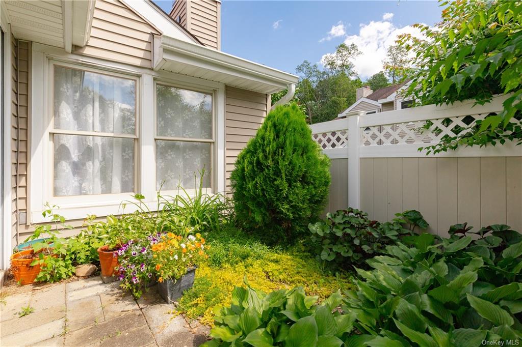 a house with a lot of flower in front of it