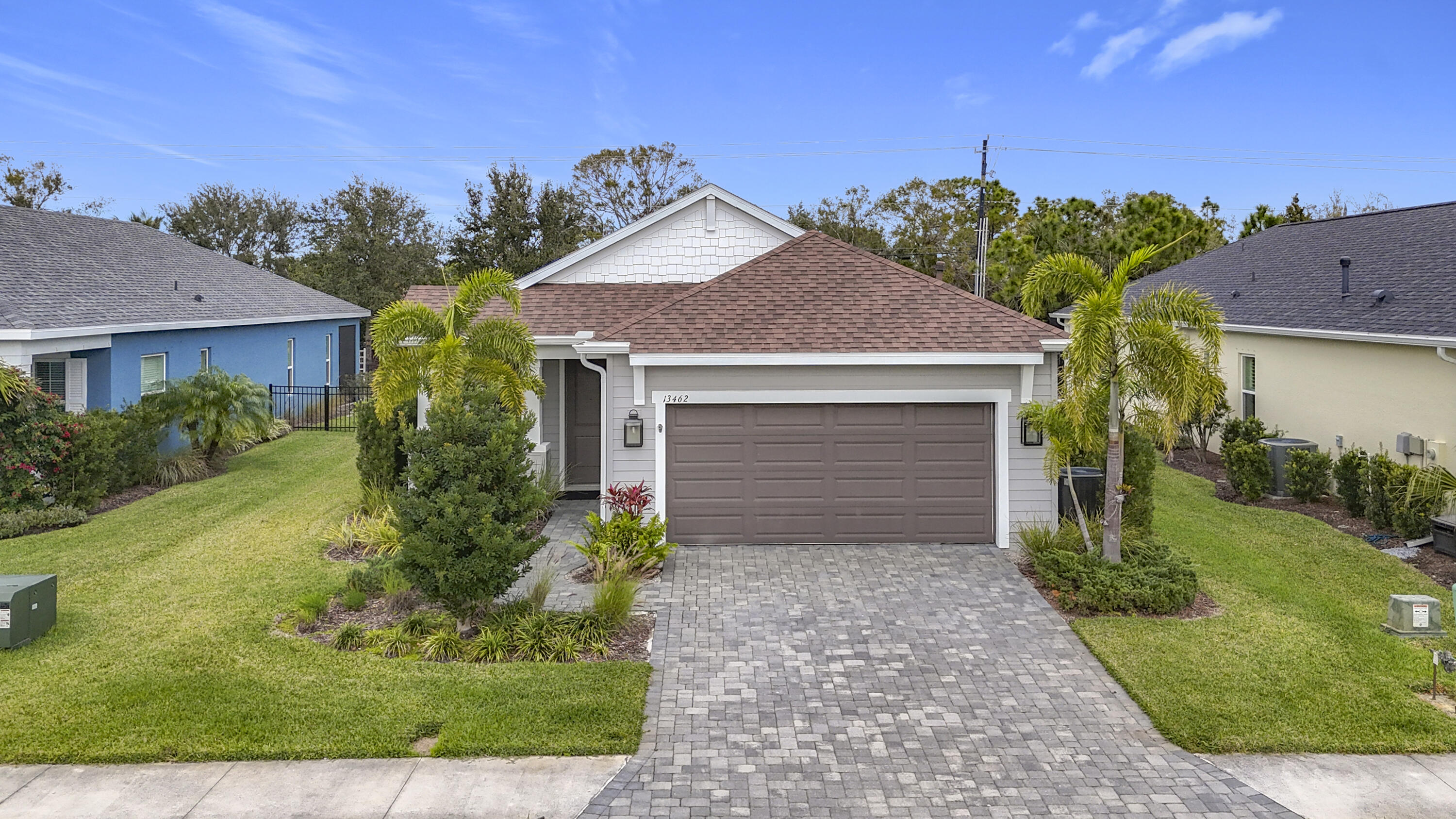 a front view of a house with a yard and garage