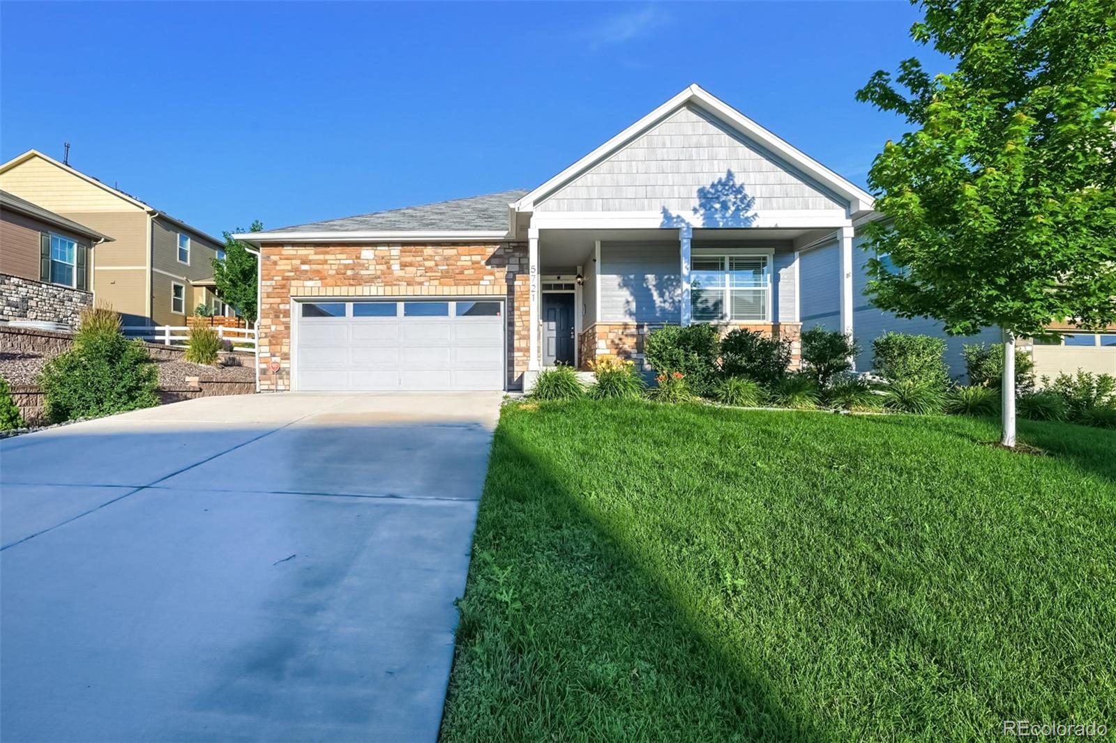 a front view of a house with a yard and porch