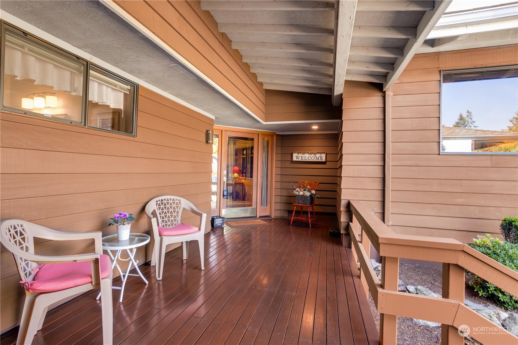 a backyard of a house with table and chairs