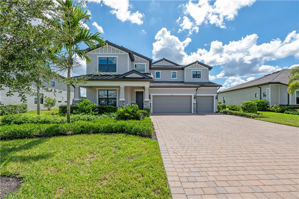 a front view of a house with a yard and garage