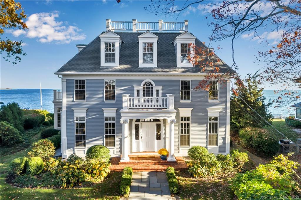 Stunning Georgian Colonial located on the highest shoreline point between New Haven and New London, grand columns, professional landscaping on a tree lined street only enhance the waterview.