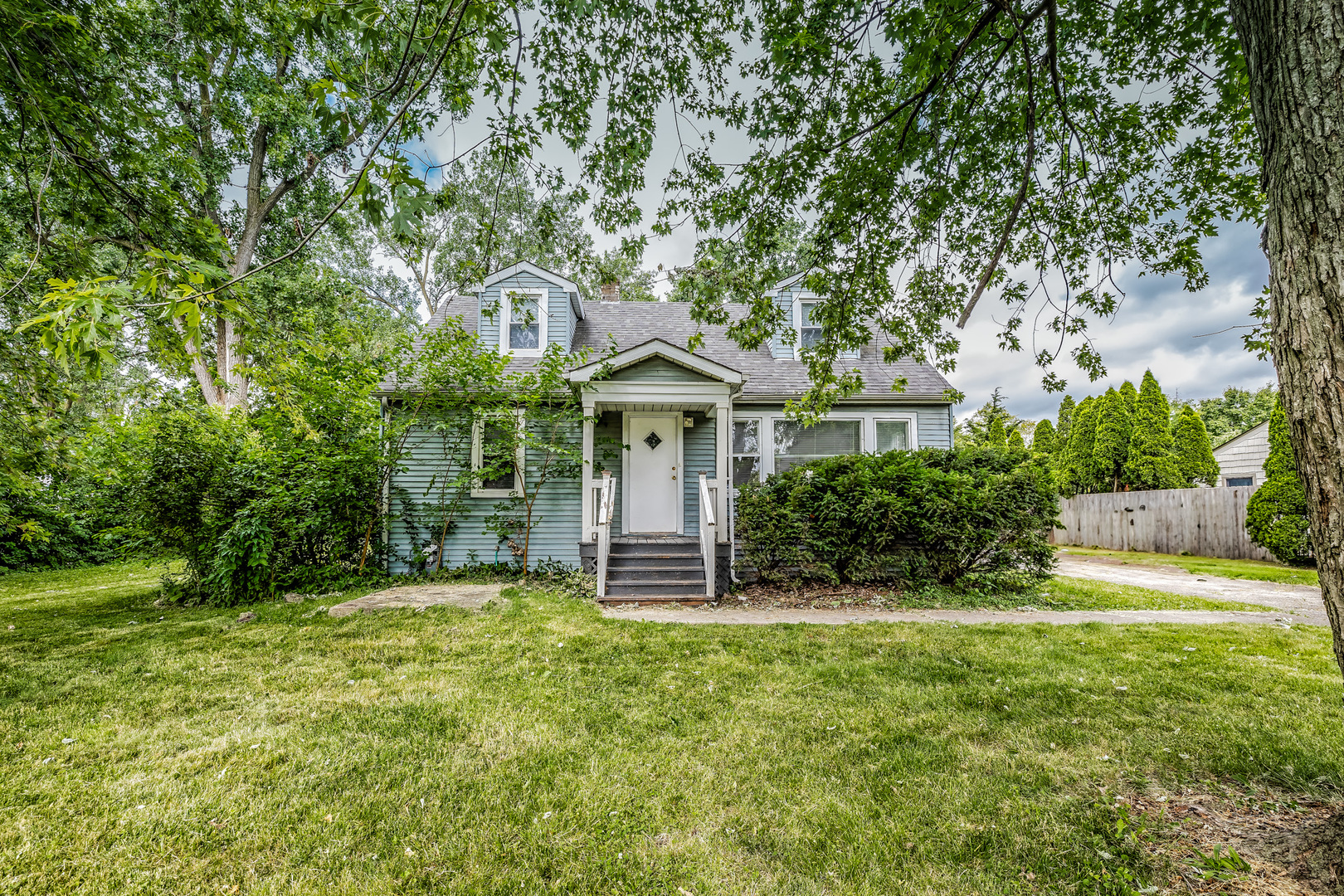 a front view of a house with a garden