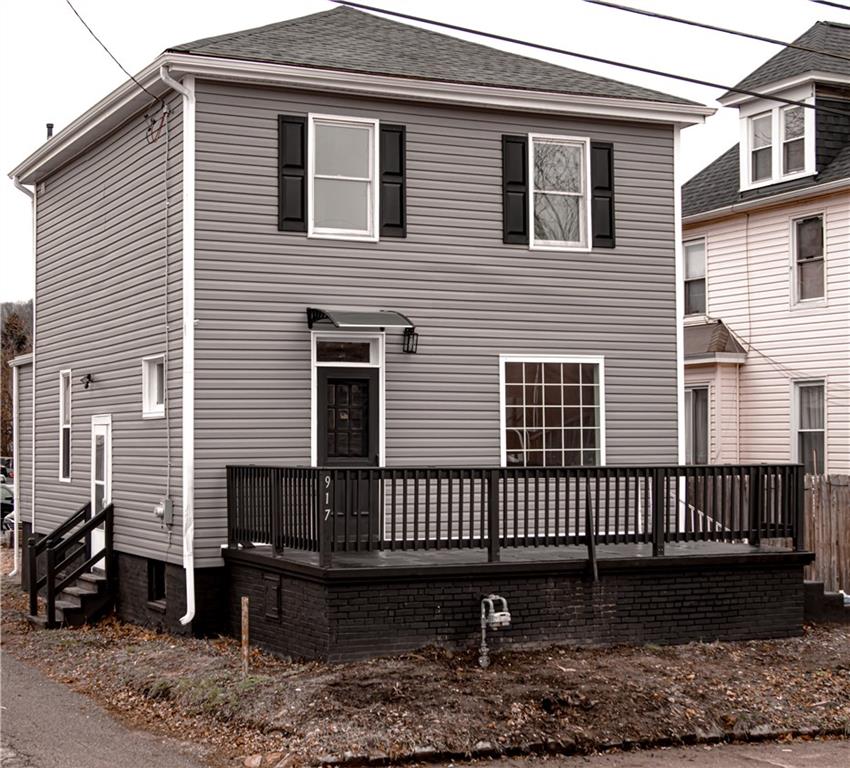 a view of a house with a yard and wooden floor