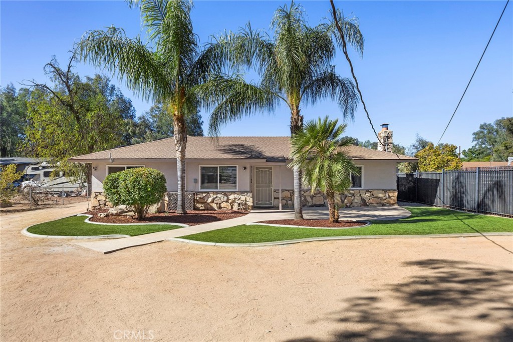 a front view of house with yard and green space