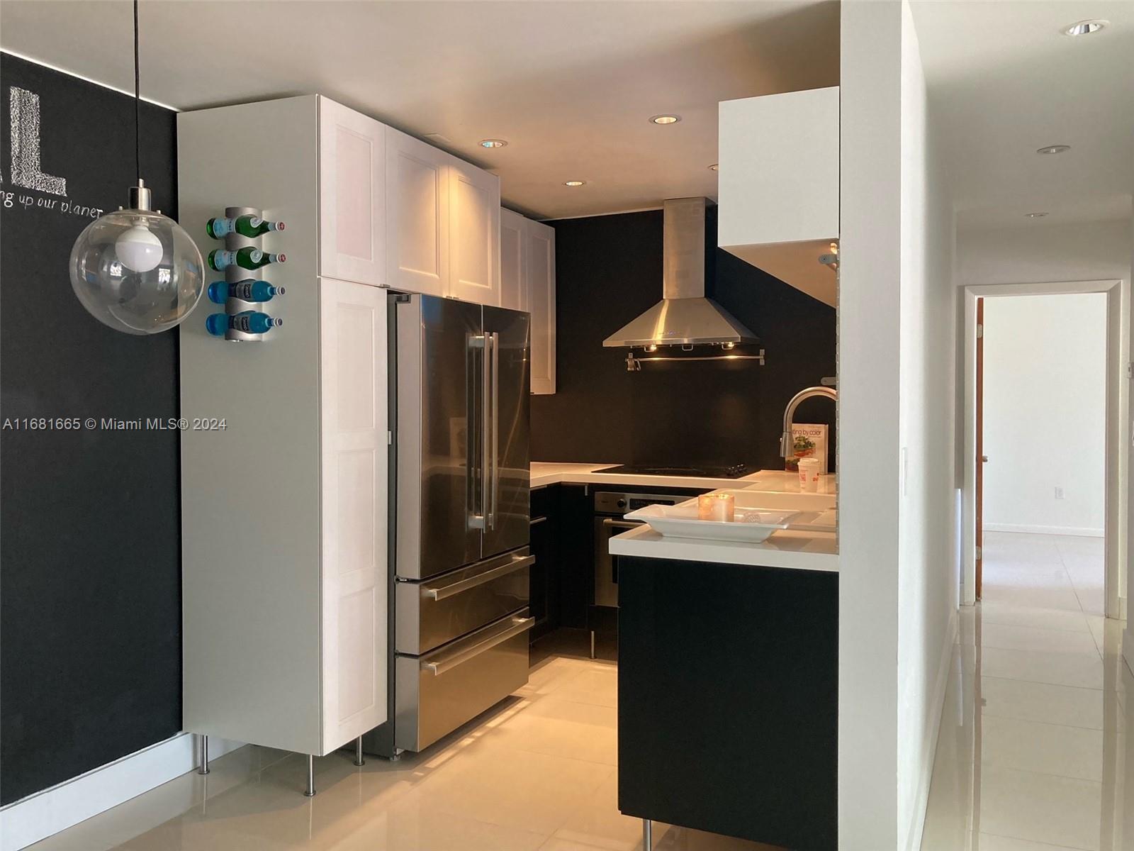 a kitchen with refrigerator and window