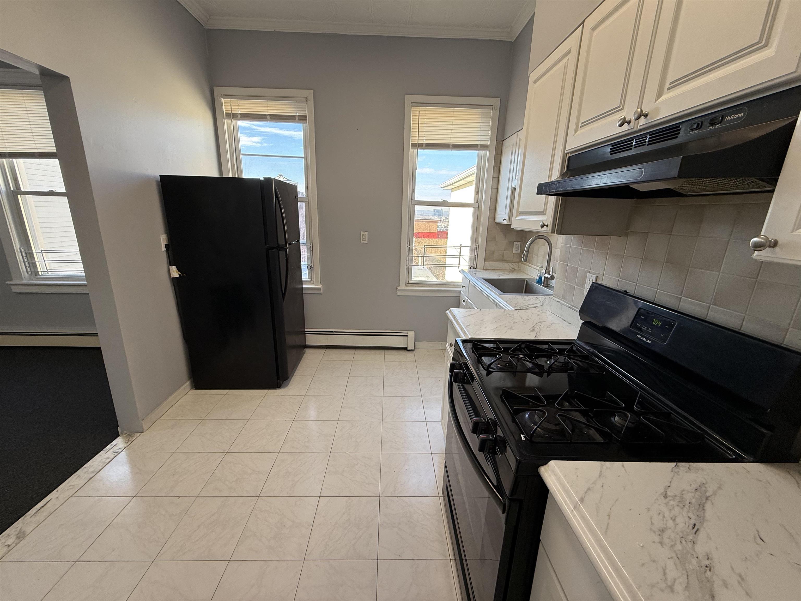 a kitchen with a stove and a refrigerator