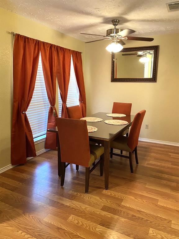 a view of a dining room with furniture and a window