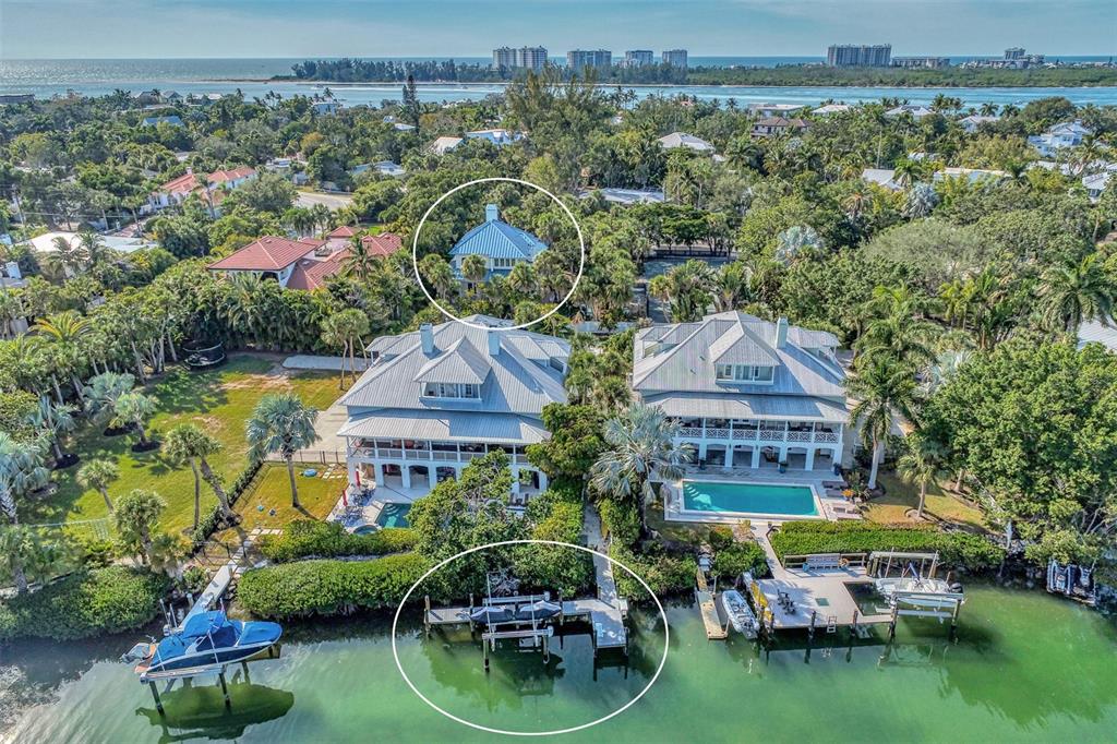 an aerial view of a house with garden space and lake view