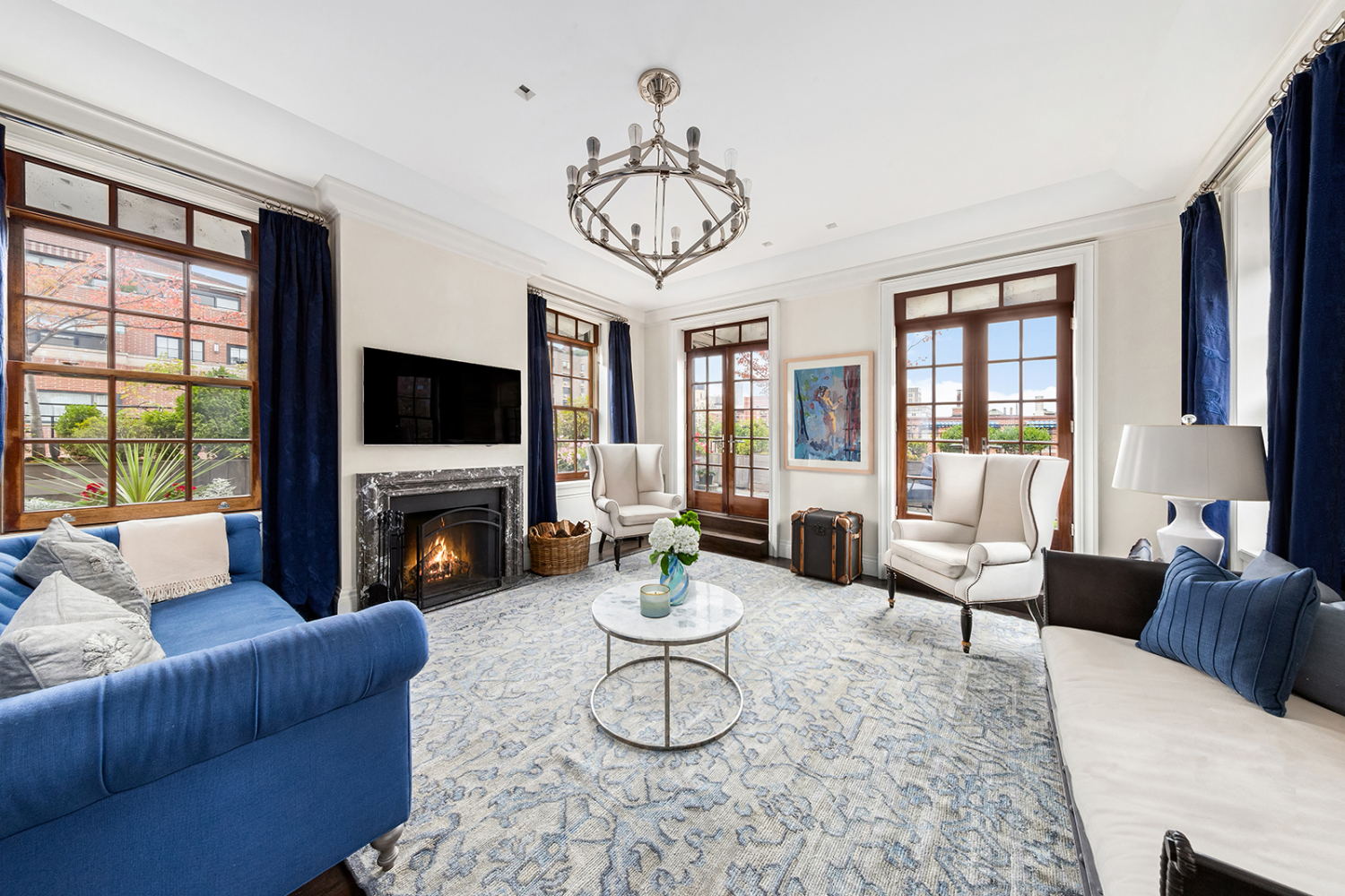 a living room with furniture a fireplace and a flat screen tv