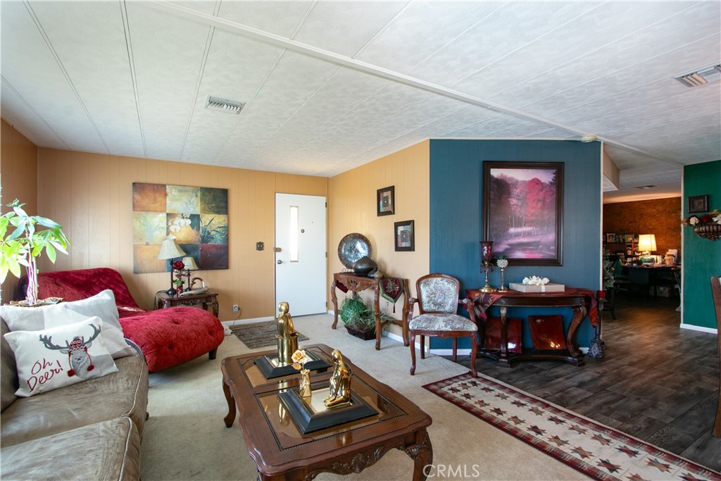 a living room with furniture fireplace and window