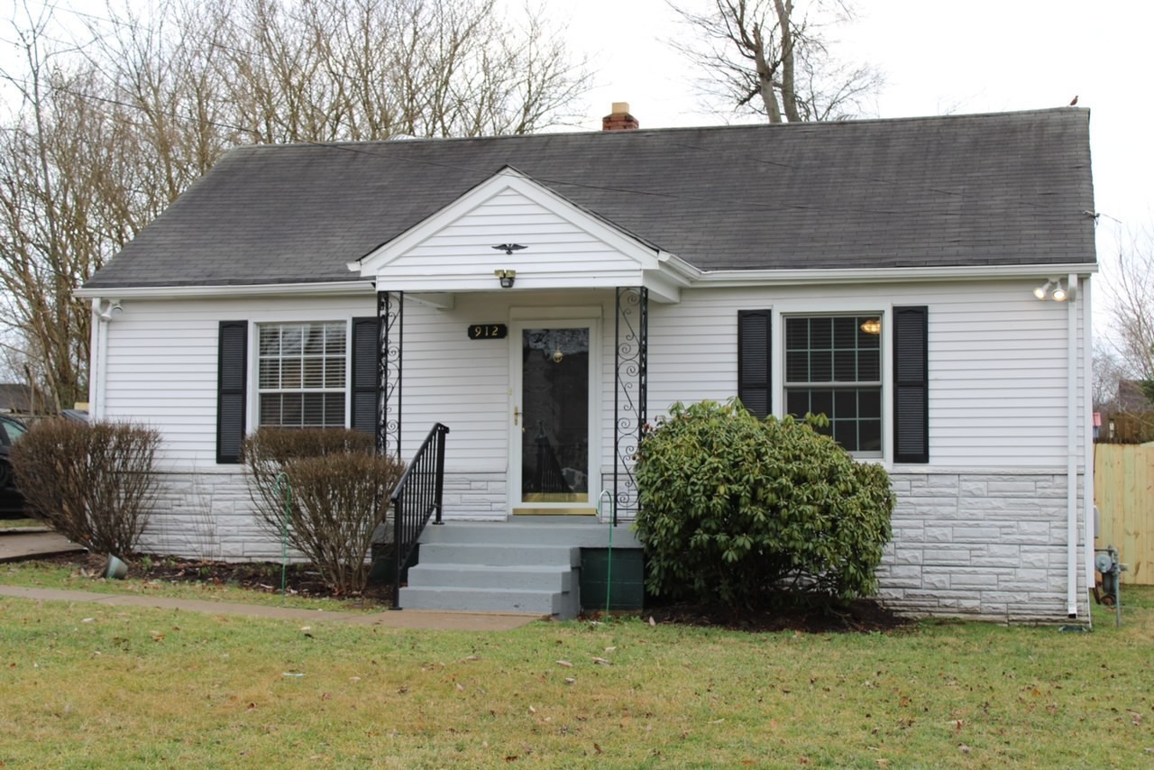 a view of house with backyard and garden