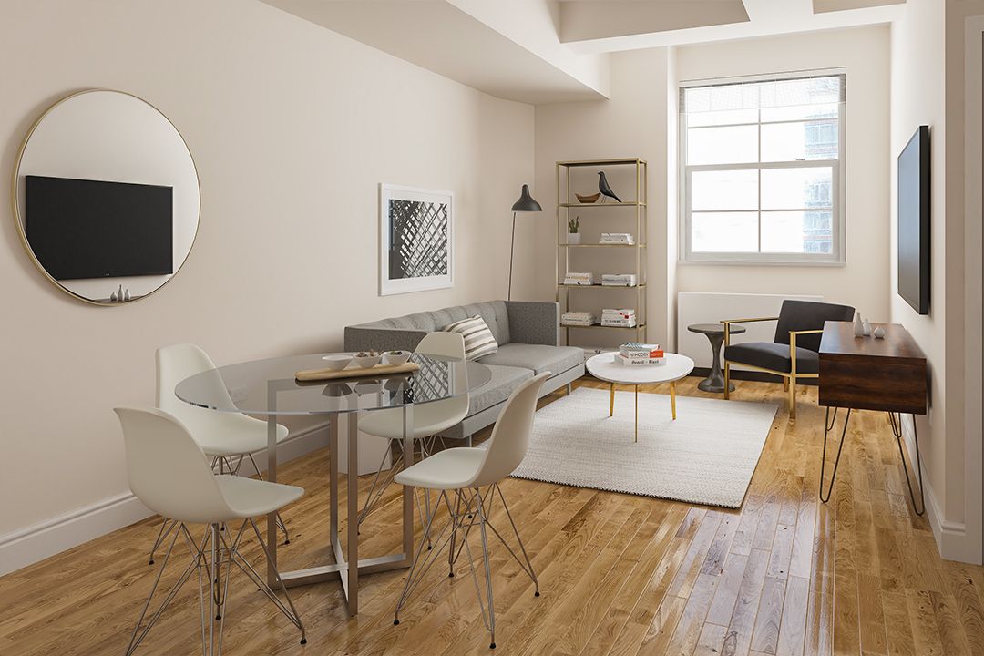 a living room with a couch and a wooden floor