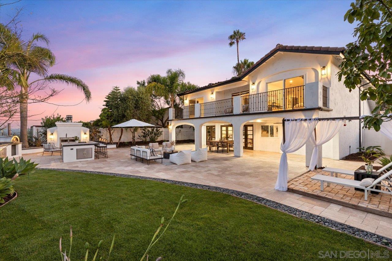 a front view of a house with a garden and patio