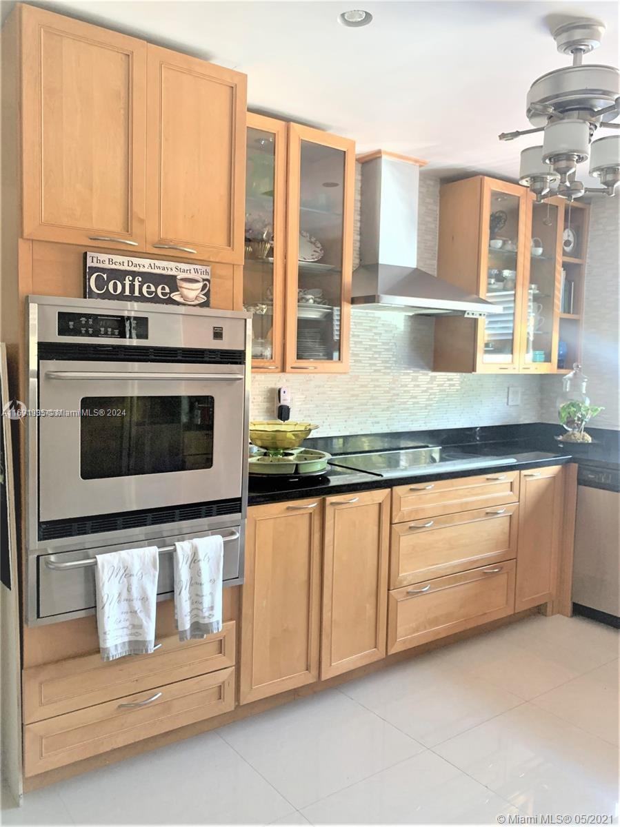 a kitchen with granite countertop a stove and a sink