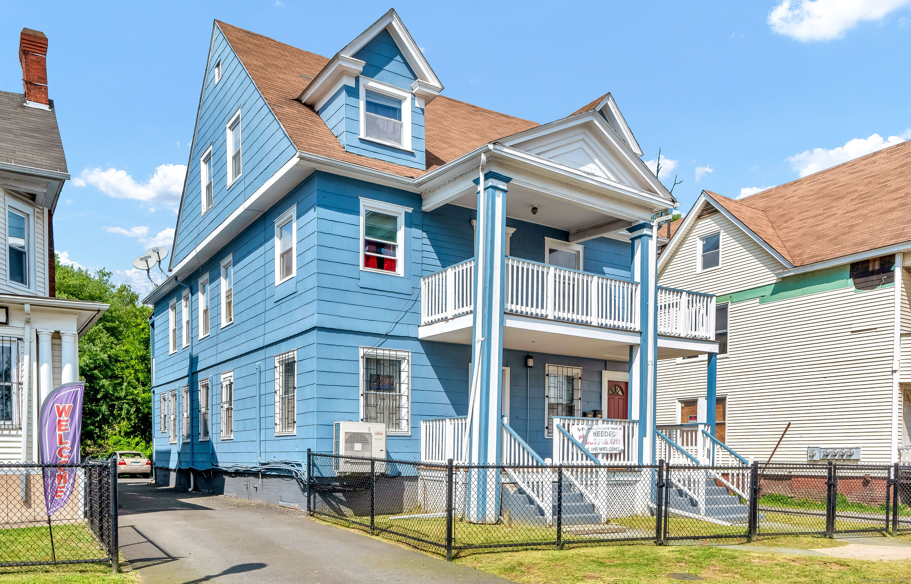 a front view of a residential apartment building with a yard