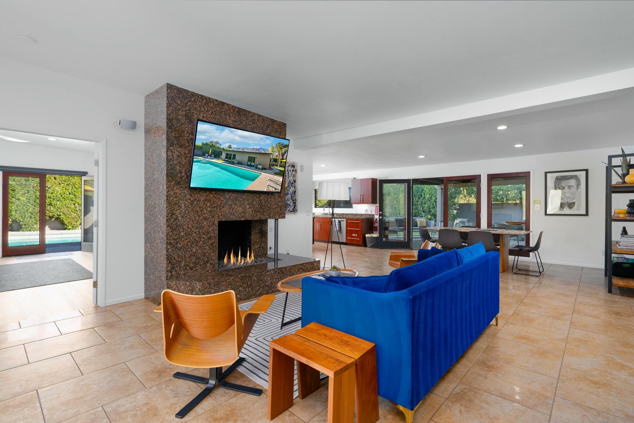 a living room with furniture a flat screen tv and a fireplace