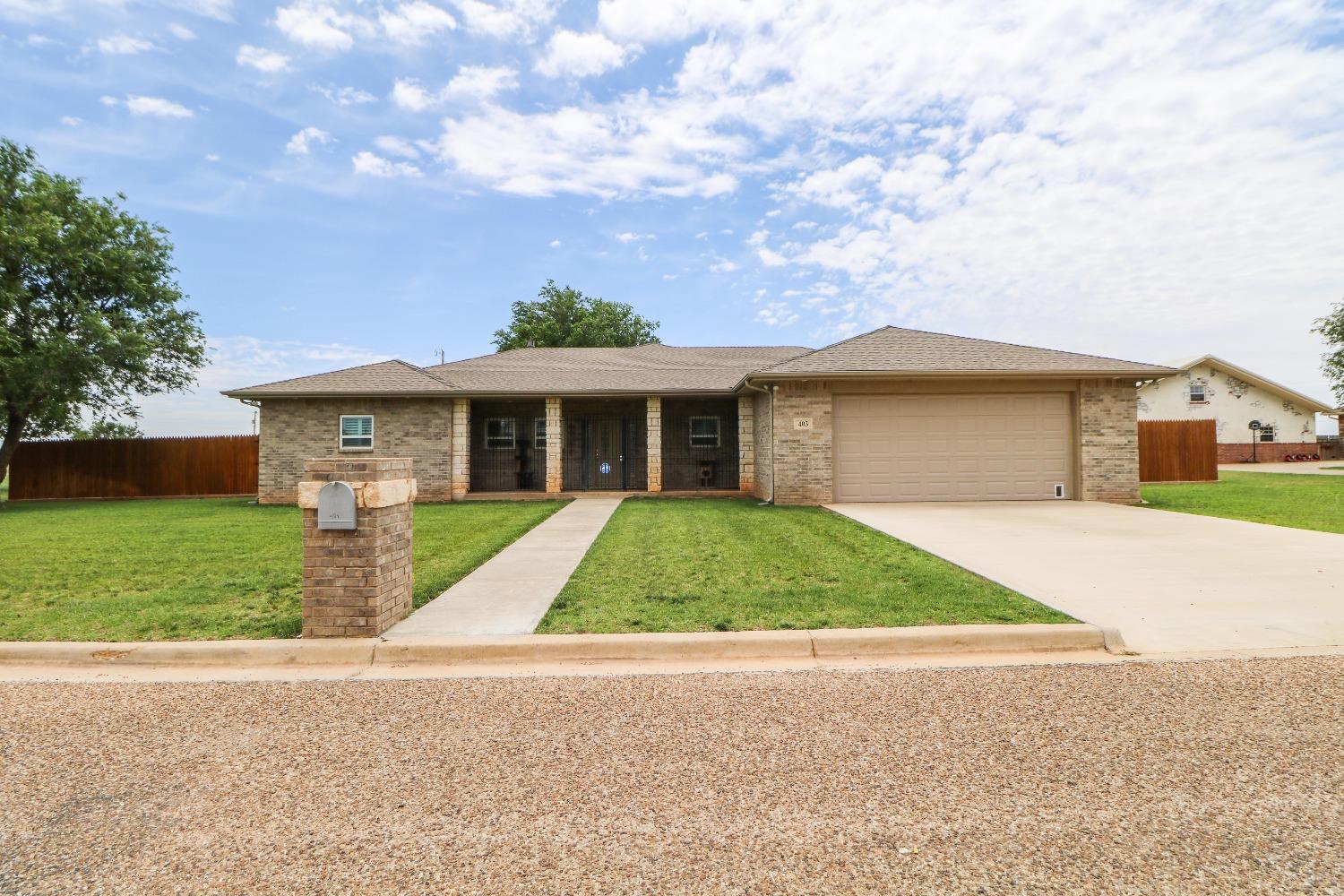 a front view of house with yard and green space