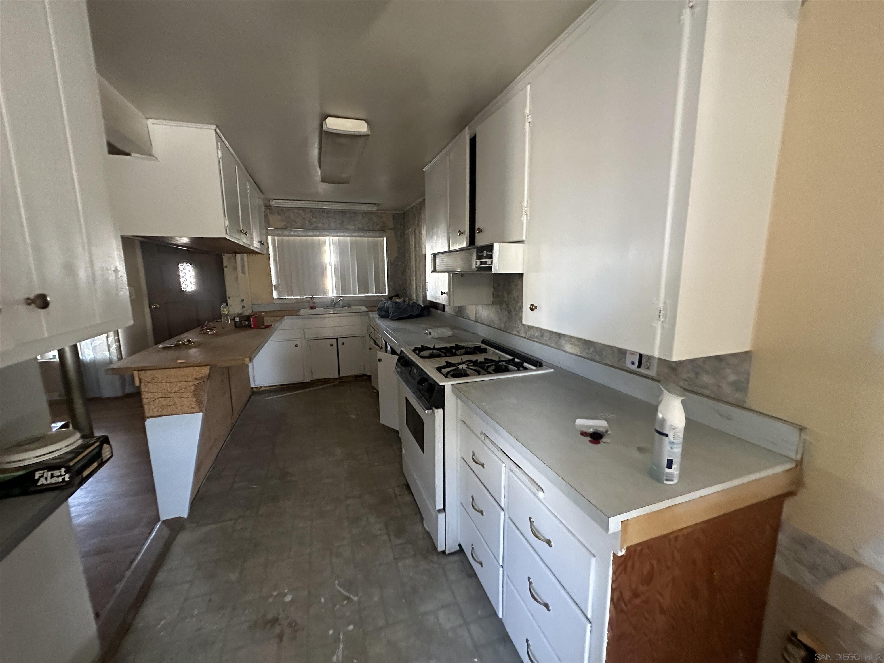 a kitchen with a sink stove and cabinets