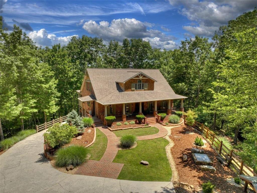 a front view of a house with garden view and trees