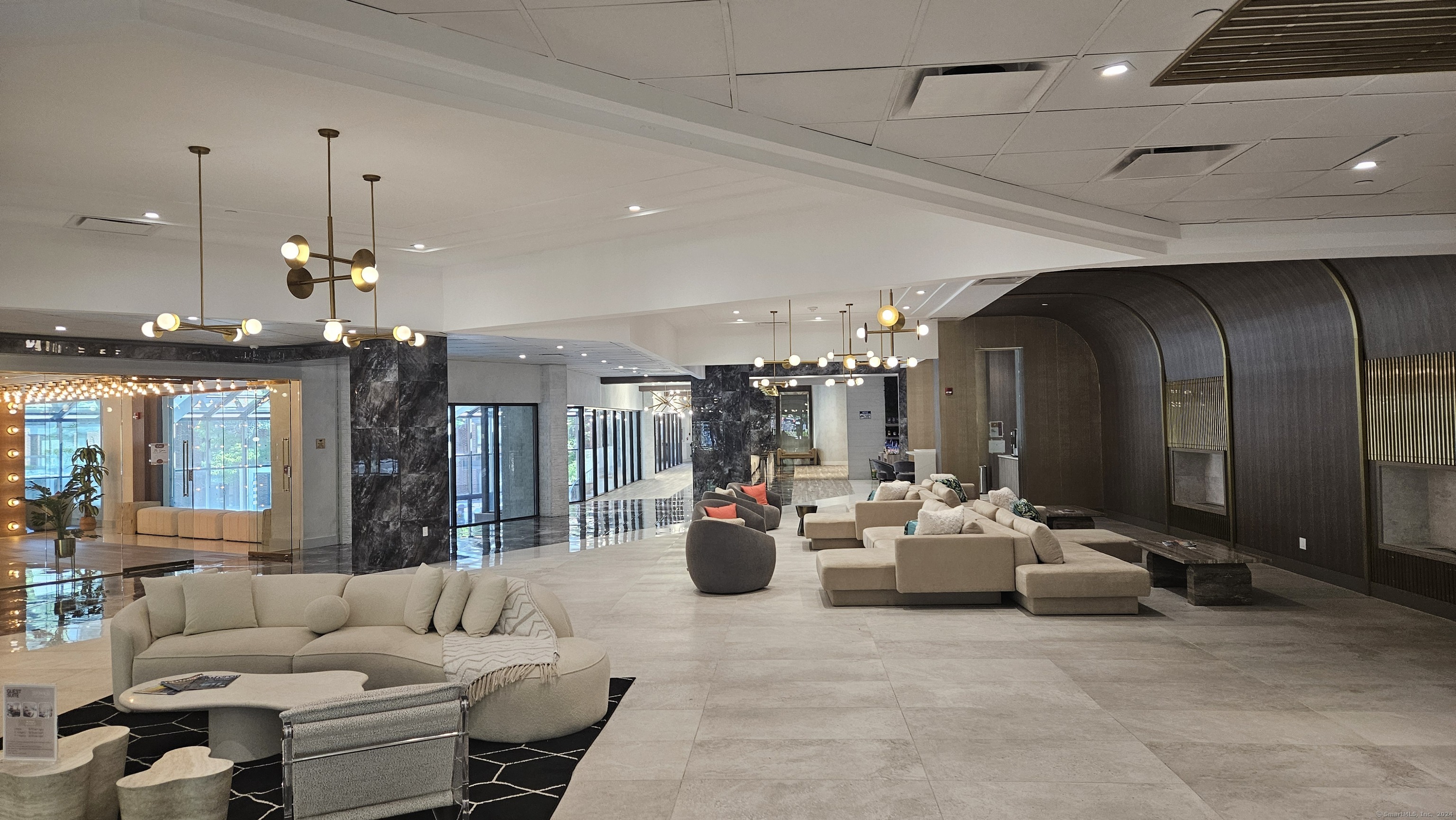 a living room with furniture and chandelier