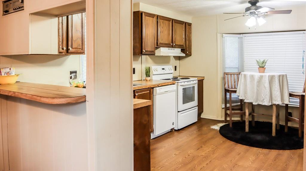 a kitchen with kitchen island a stove a sink and a microwave