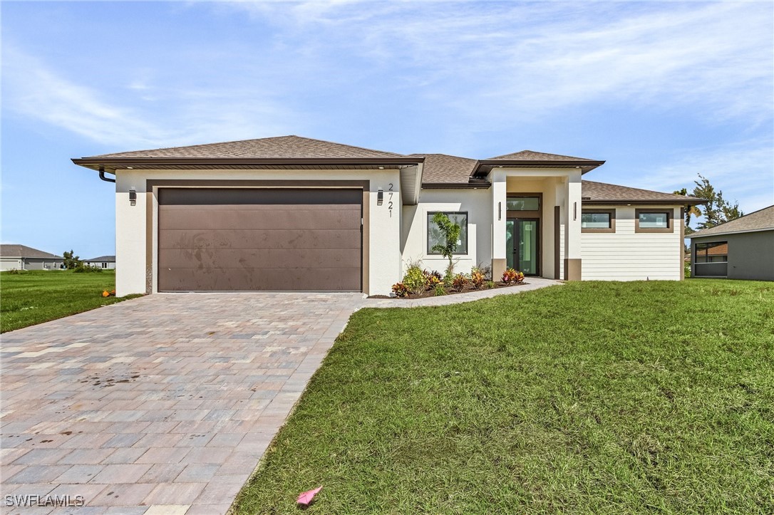 a front view of a house with a yard and garage