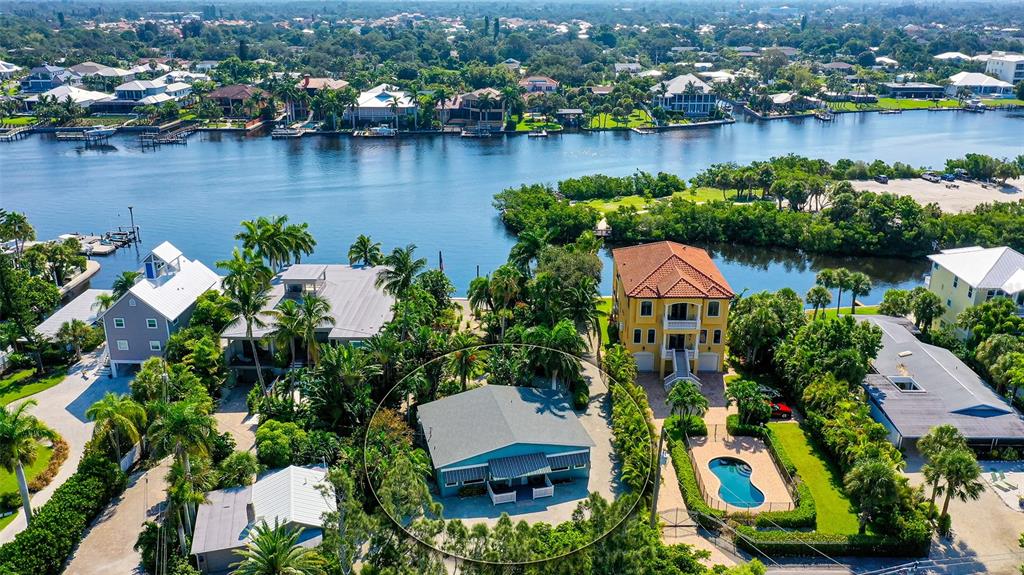 an aerial view of residential house with outdoor space and lake view