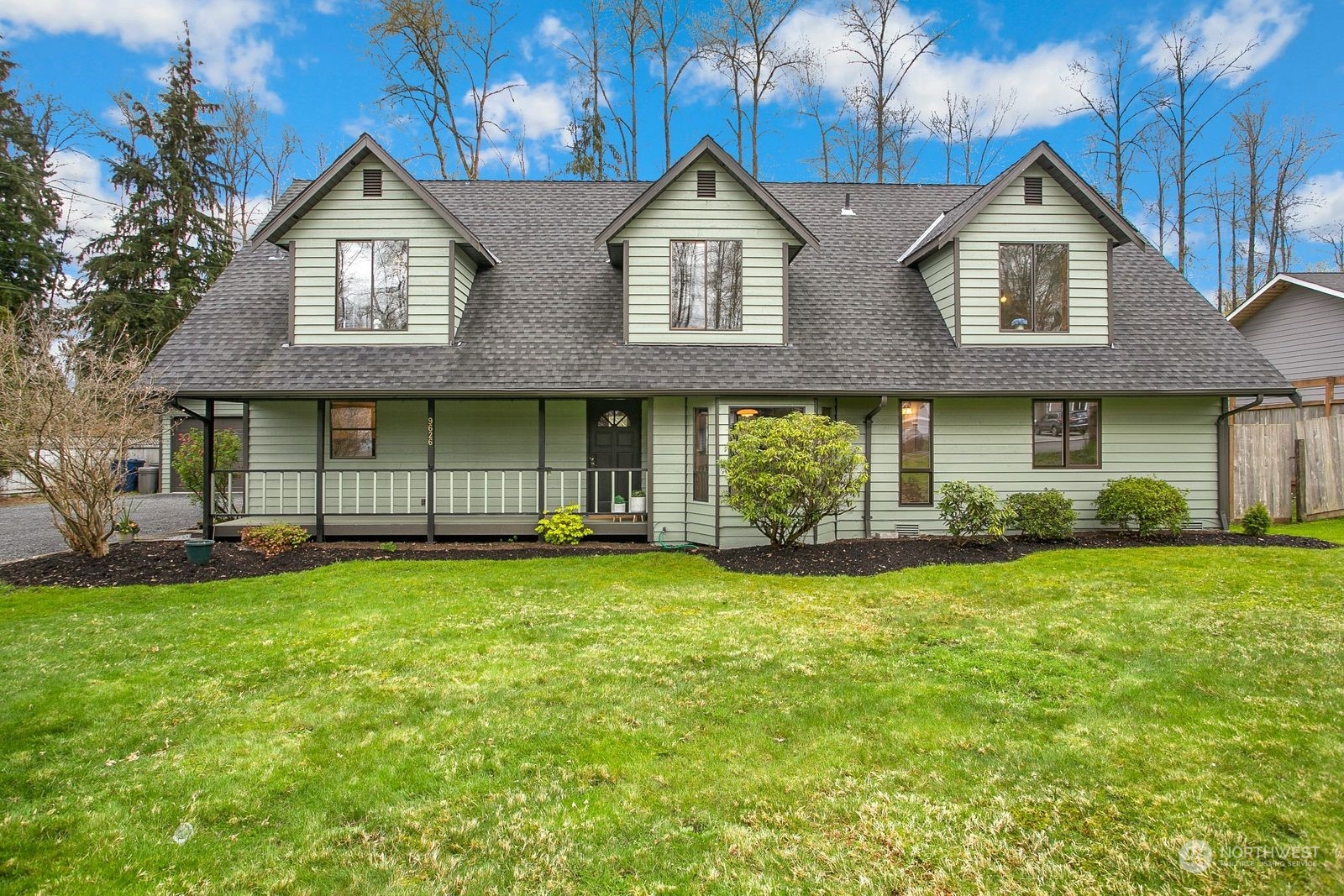 a front view of a house with a garden