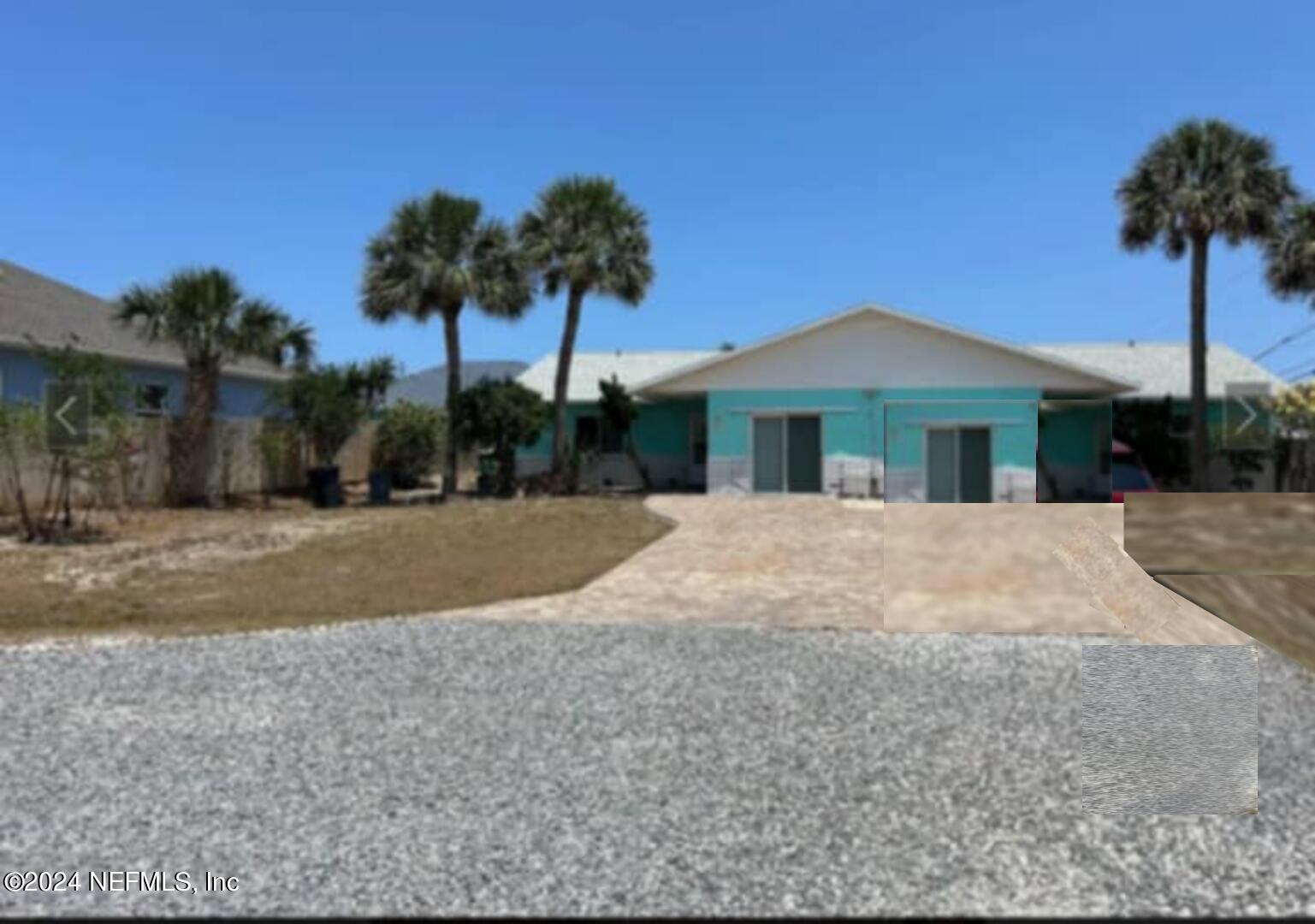 a view of house with outdoor space and palm tree