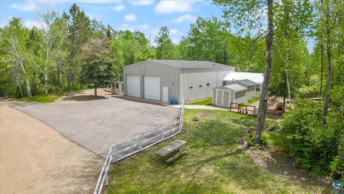 Exterior space with an outdoor structure, a lawn, and a garage