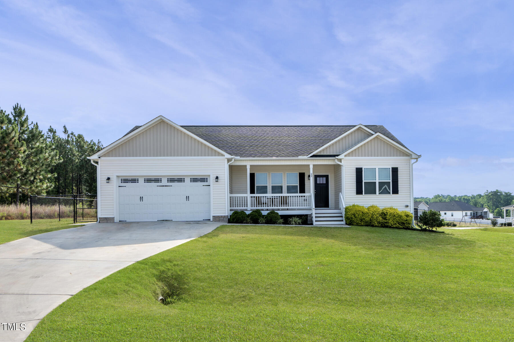 a front view of a house with a garden and yard