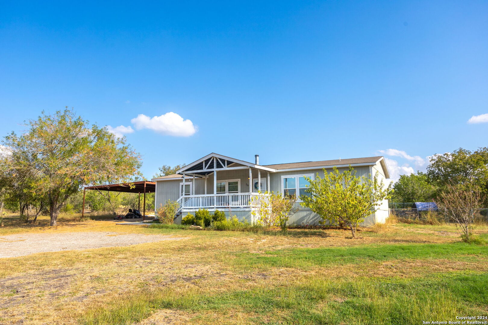 a front view of a house with a big yard