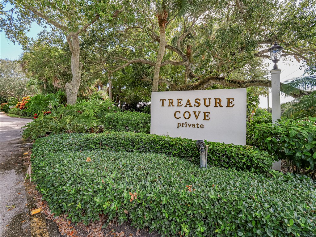 a sign broad in front of flowers