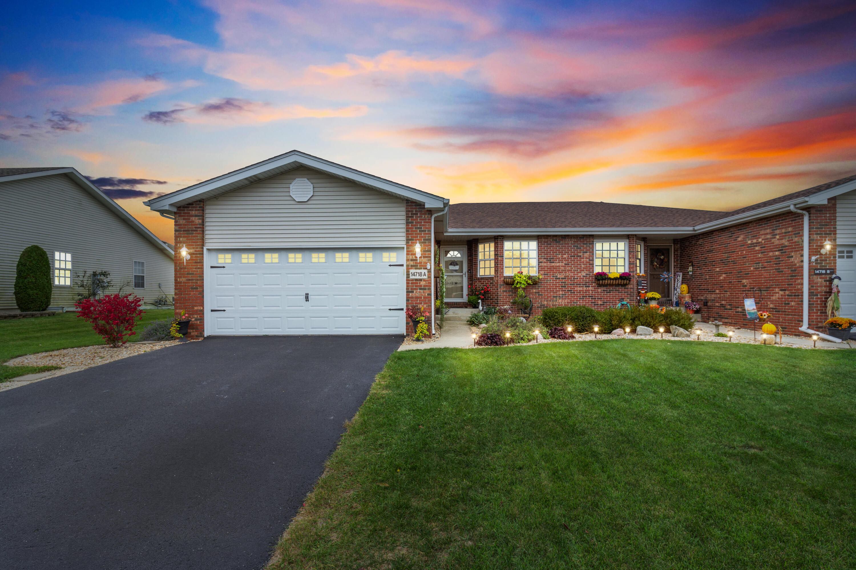 a front view of house with yard and green space