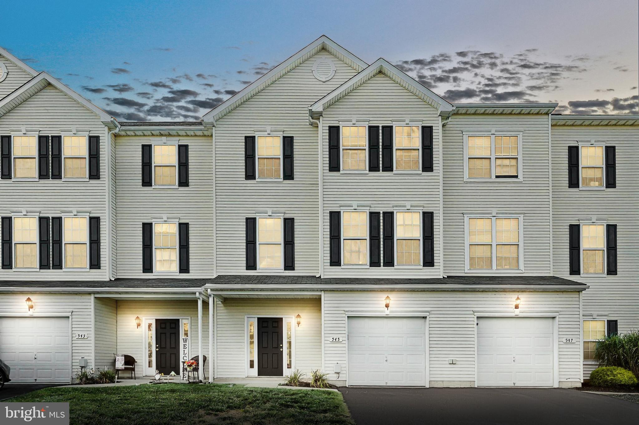 a front view of a residential apartment building with a yard