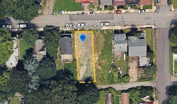 an aerial view of residential houses with outdoor space and parking