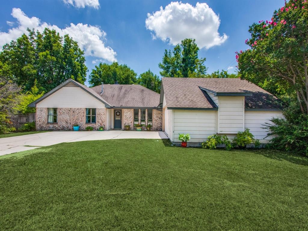 a aerial view of a house with a big yard plants and large tree