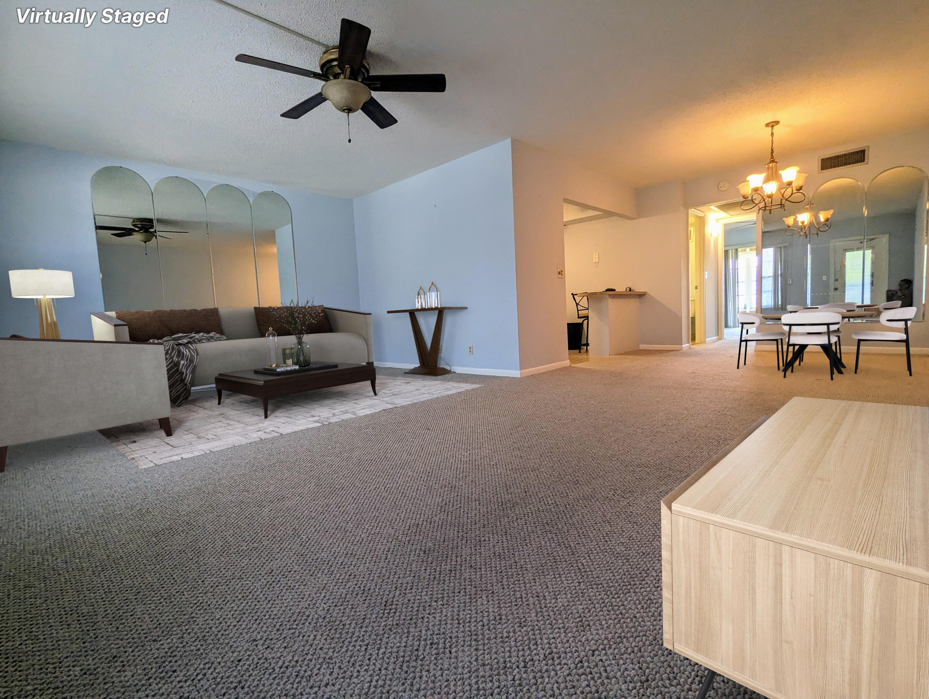 a living room with furniture and a chandelier