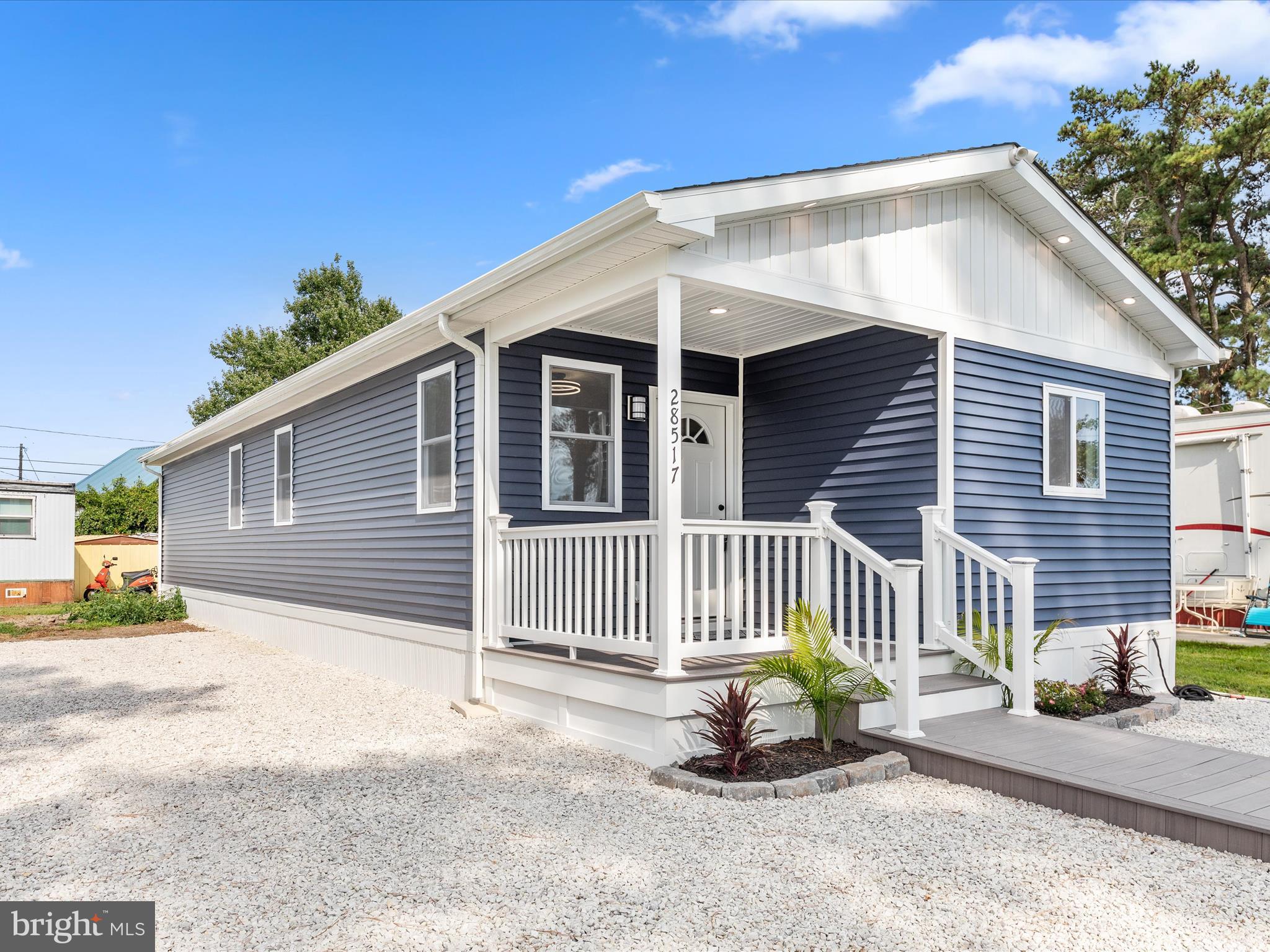 a side view of a house with a patio and a yard