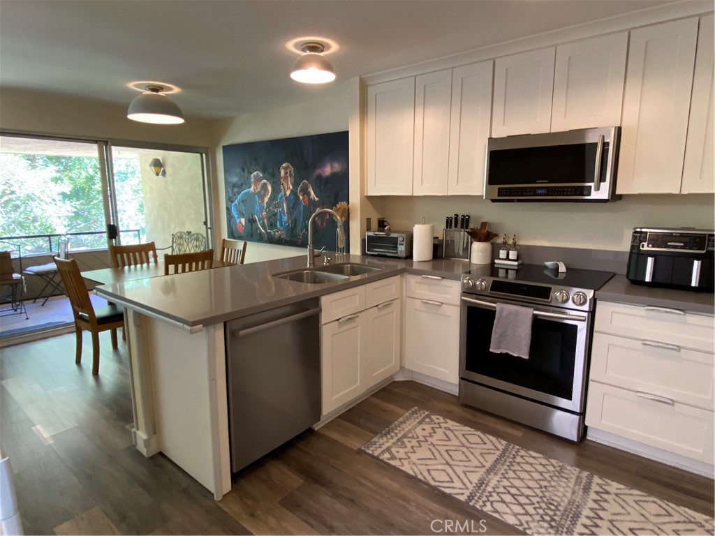 a kitchen with a sink stove and microwave