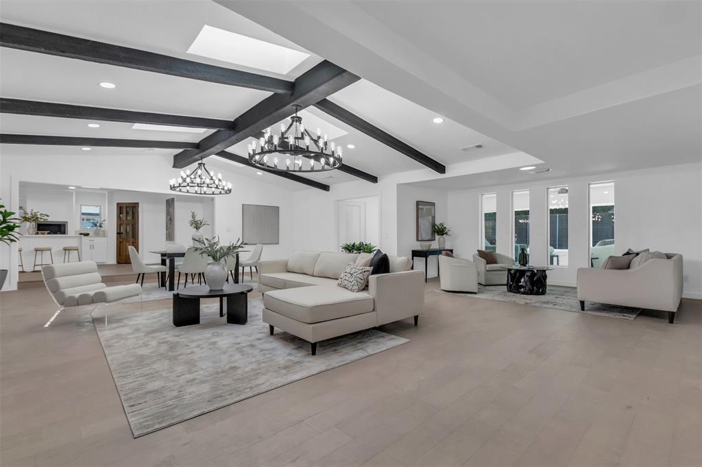 a living room with furniture and a large mirror