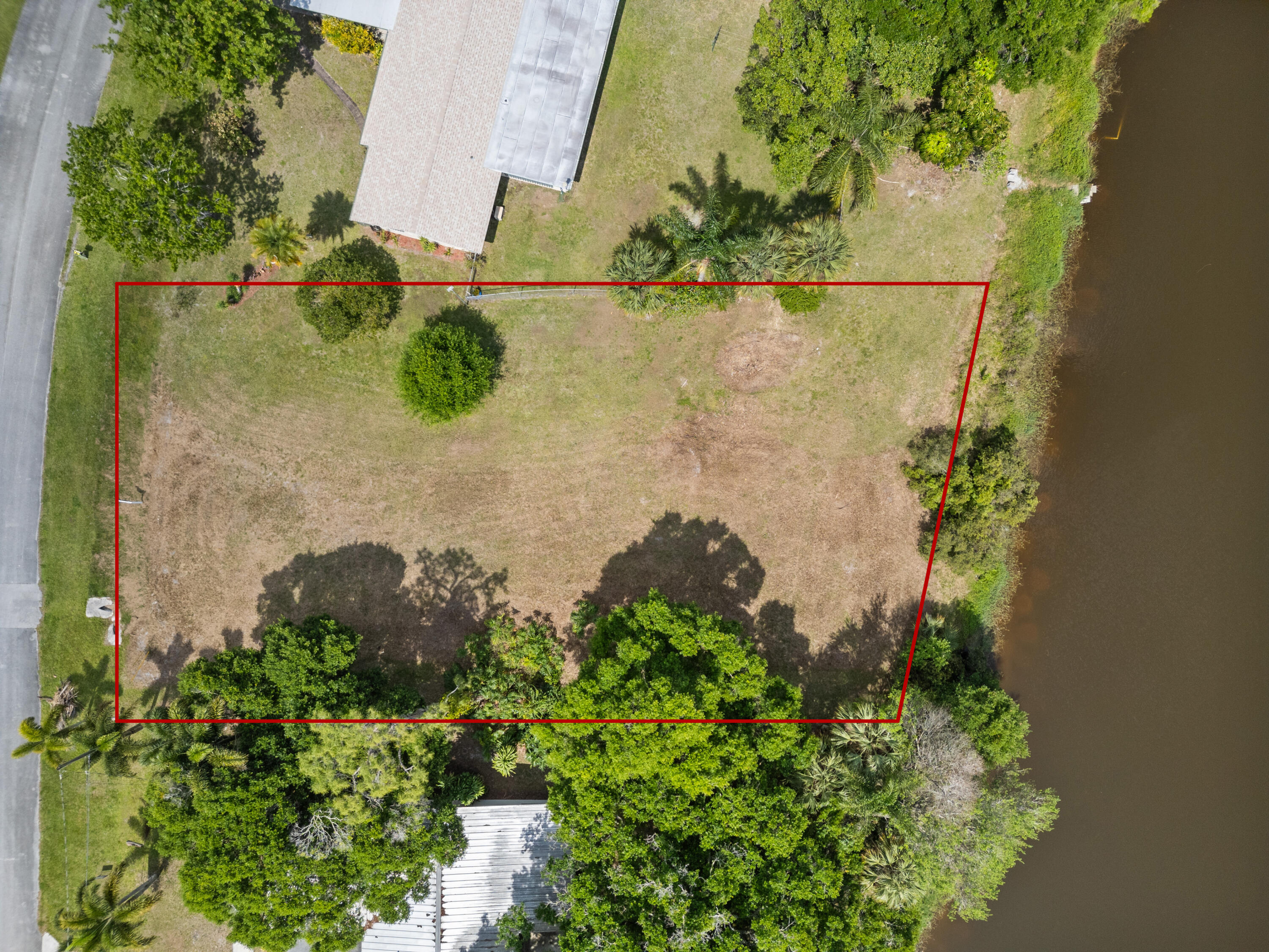 an aerial view of a house with a yard and plants