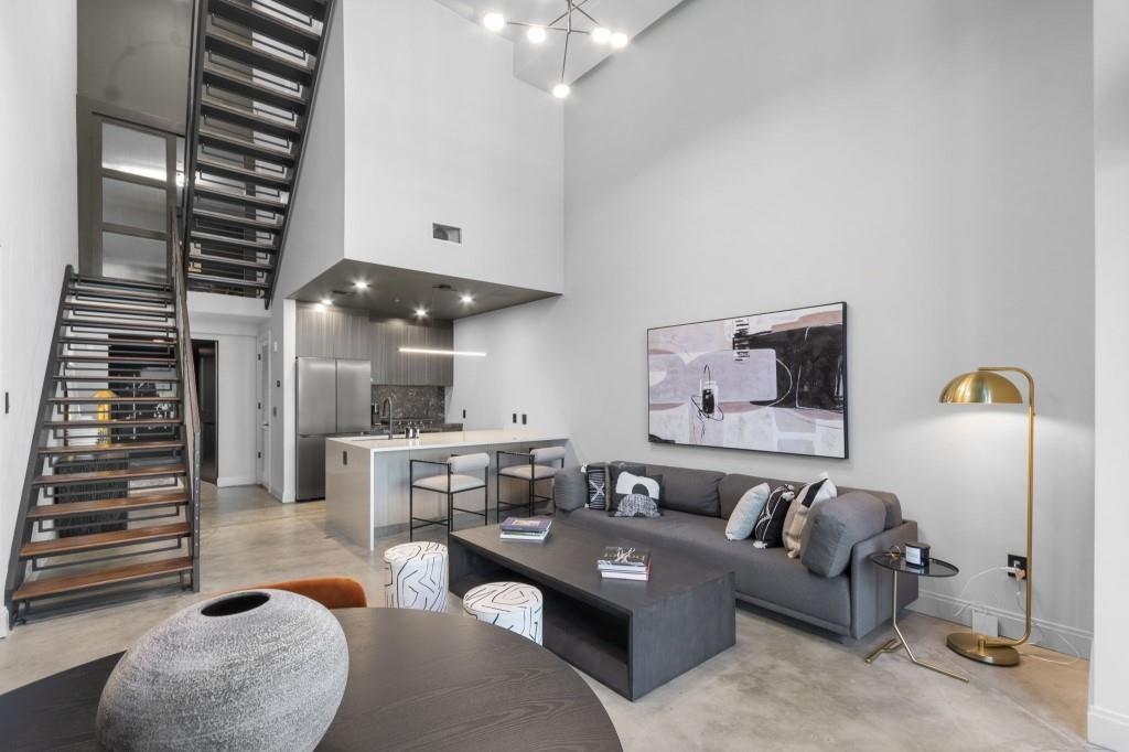 a living room with furniture and a chandelier